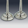 Circular silver candlestick bases with hallmarks to top surfaces